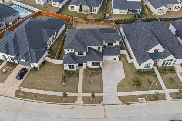an aerial view of residential houses with outdoor space