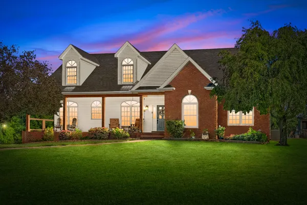 a front view of a house with a garden