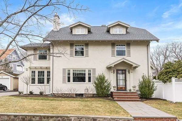 a front view of a house with a yard