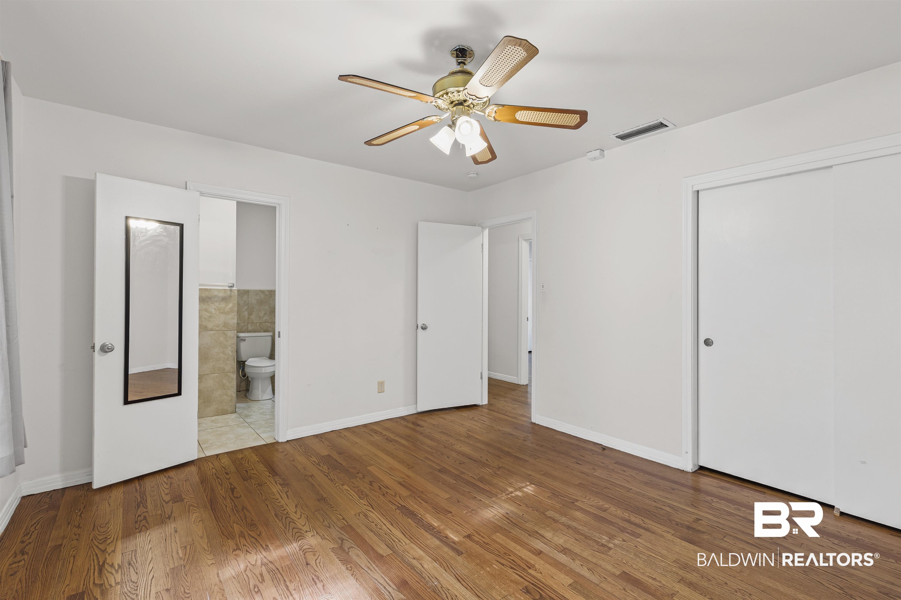1108 Locarno Street Mobile, AL 36608 - Photo 18 of 24 Unfurnished bedroom with wood finished floors, a closet, ensuite bathroom, and ceiling fan
