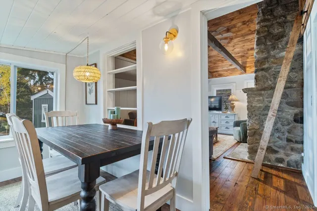 a view of a dining room with furniture and a window