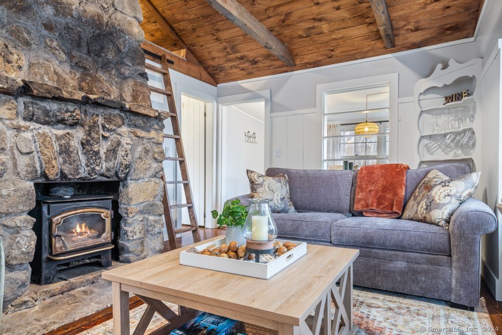 5 Old Clark Hill Road East Hampton, CT 06424 - Photo 8 of 20 a living room with furniture and a fireplace