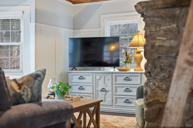 a living room with furniture and a flat screen tv