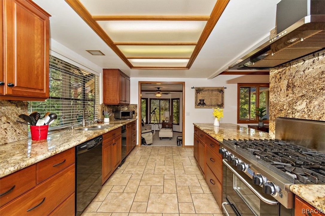 641 Golf Course Road Lake Arrowhead, CA 92352 - Photo 15 of 46 a large kitchen with stainless steel appliances granite countertop a stove and large cabinets