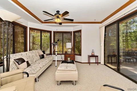 a living room with furniture and large windows