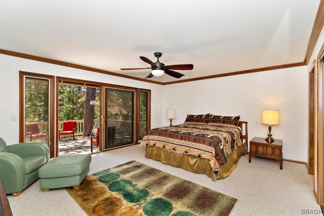 641 Golf Course Road Lake Arrowhead, CA 92352 - Photo 23 of 46 a spacious bedroom with a bed and glass walk in closet