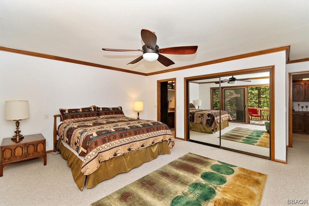 641 Golf Course Road Lake Arrowhead, CA 92352 - Photo 24 of 46 a spacious bedroom with a bed and large mirror