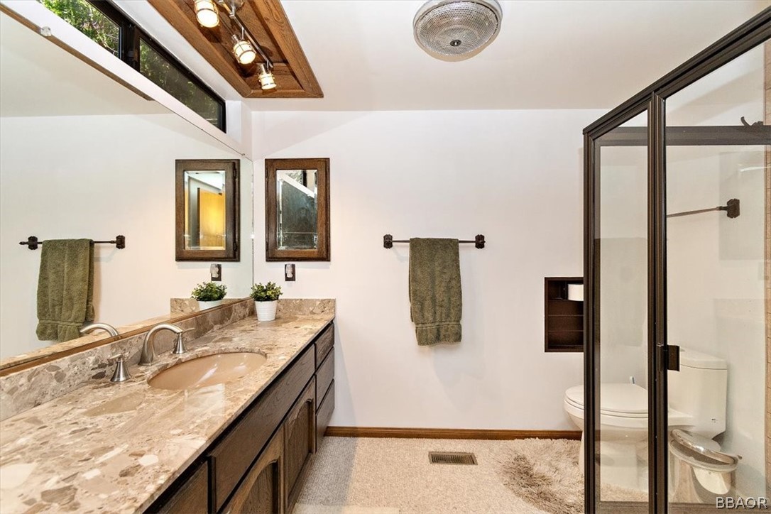 641 Golf Course Road Lake Arrowhead, CA 92352 - Photo 26 of 46 a bathroom with a granite countertop sink a mirror and shower