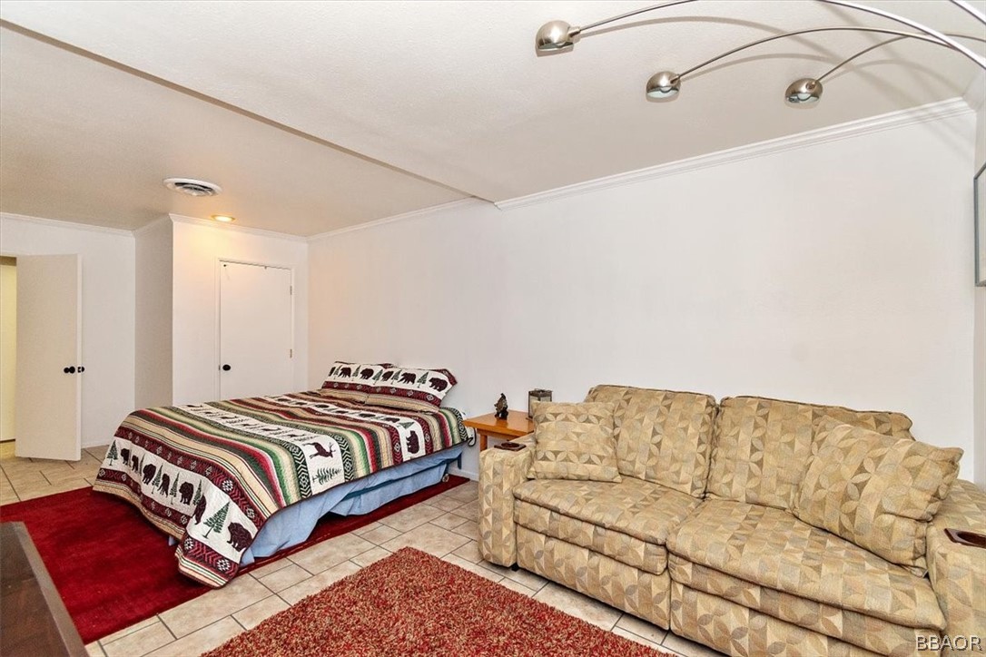 641 Golf Course Road Lake Arrowhead, CA 92352 - Photo 34 of 46 a bedroom with a bed and couch