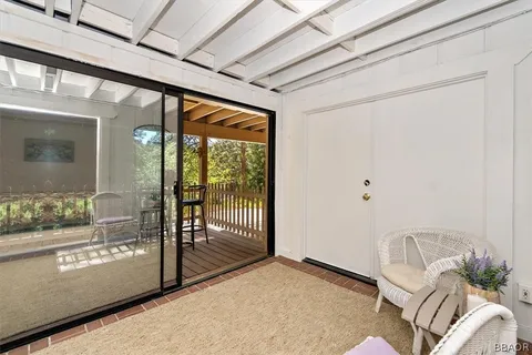 a view of a room with wooden floor and a balcony