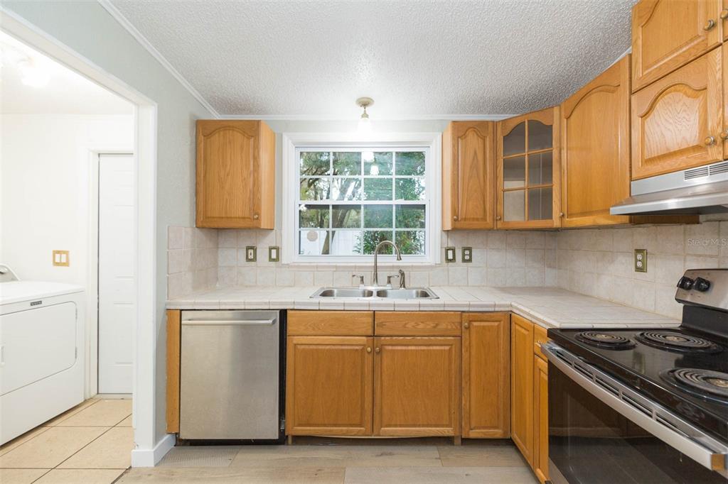 12628 Fort King Road Dade City, FL 33525 - Photo 18 of 59 a kitchen with stainless steel appliances granite countertop a sink stove and cabinets
