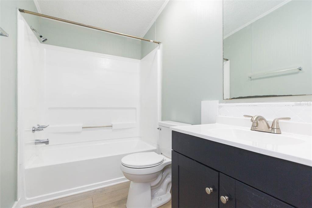 12628 Fort King Road Dade City, FL 33525 - Photo 26 of 59 a bathroom with a sink a toilet and shower