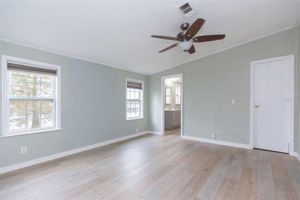 12628 Fort King Road Dade City, FL 33525 - Photo 27 of 59 a view of empty room with wooden floor and fan