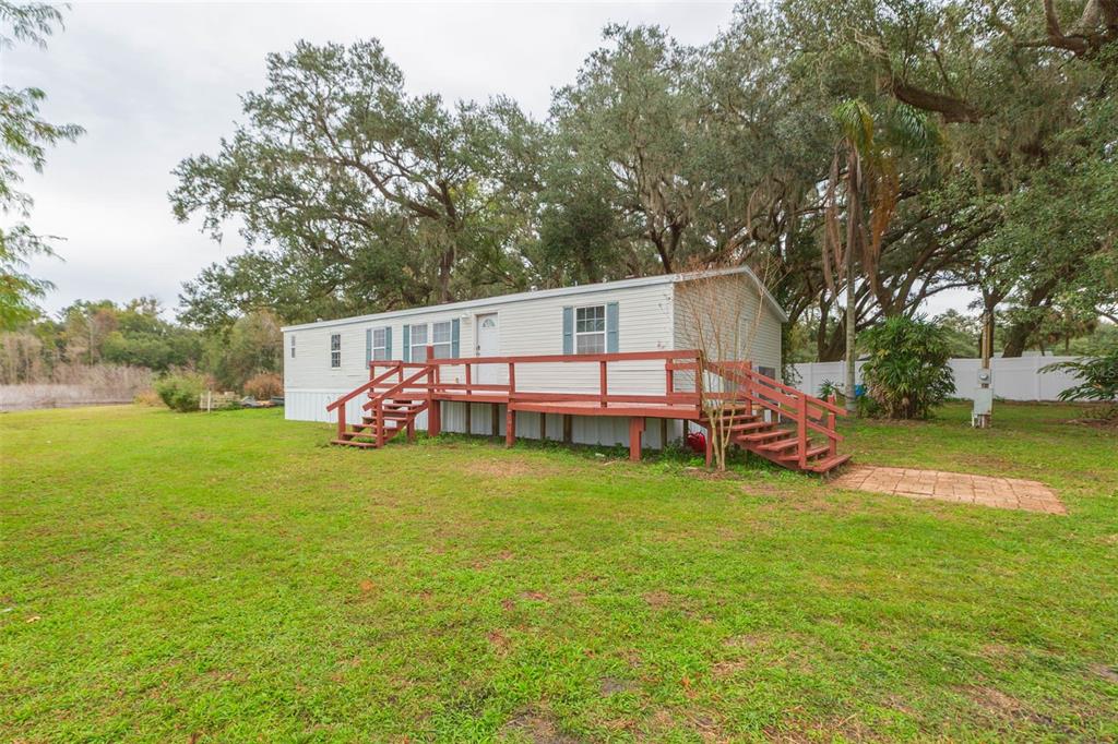 12628 Fort King Road Dade City, FL 33525 - Photo 35 of 59 a view of a house with a yard and sitting area