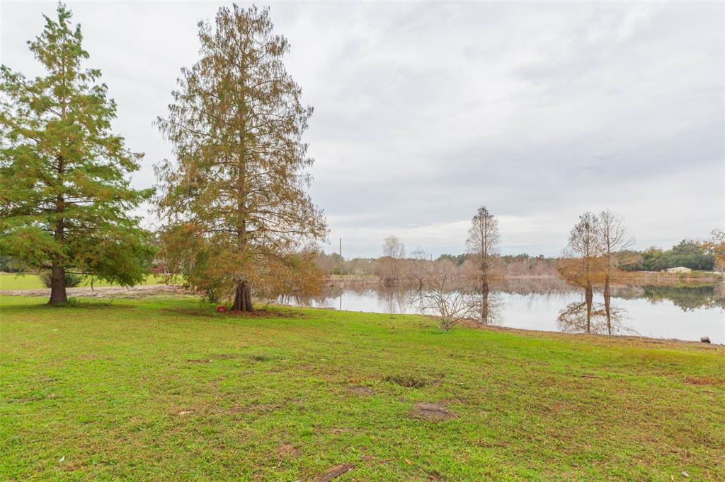 12628 Fort King Road Dade City, FL 33525 - Photo 36 of 59 a view of a lake with houses in the back