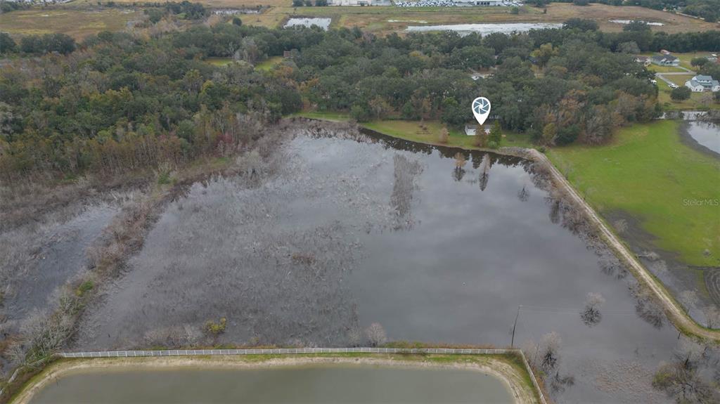 12628 Fort King Road Dade City, FL 33525 - Photo 54 of 59 a view of a swimming pool with a yard and lake view
