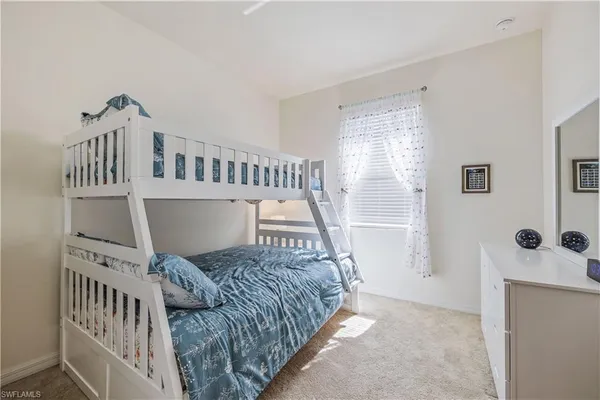 a bedroom with furniture and baby crib
