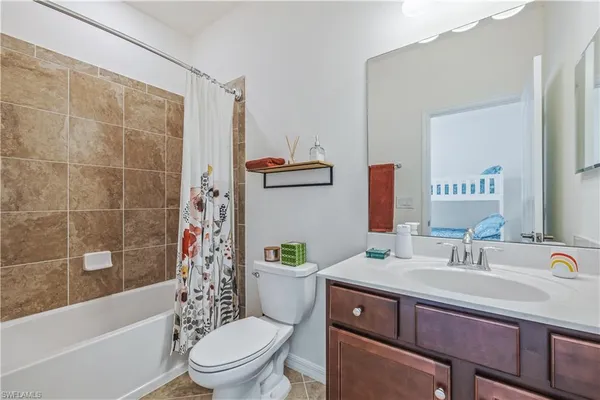 a bathroom with a sink toilet a mirror and shower