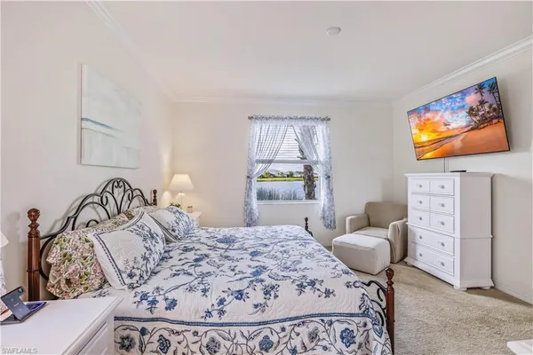 a bedroom with a bed and dresser