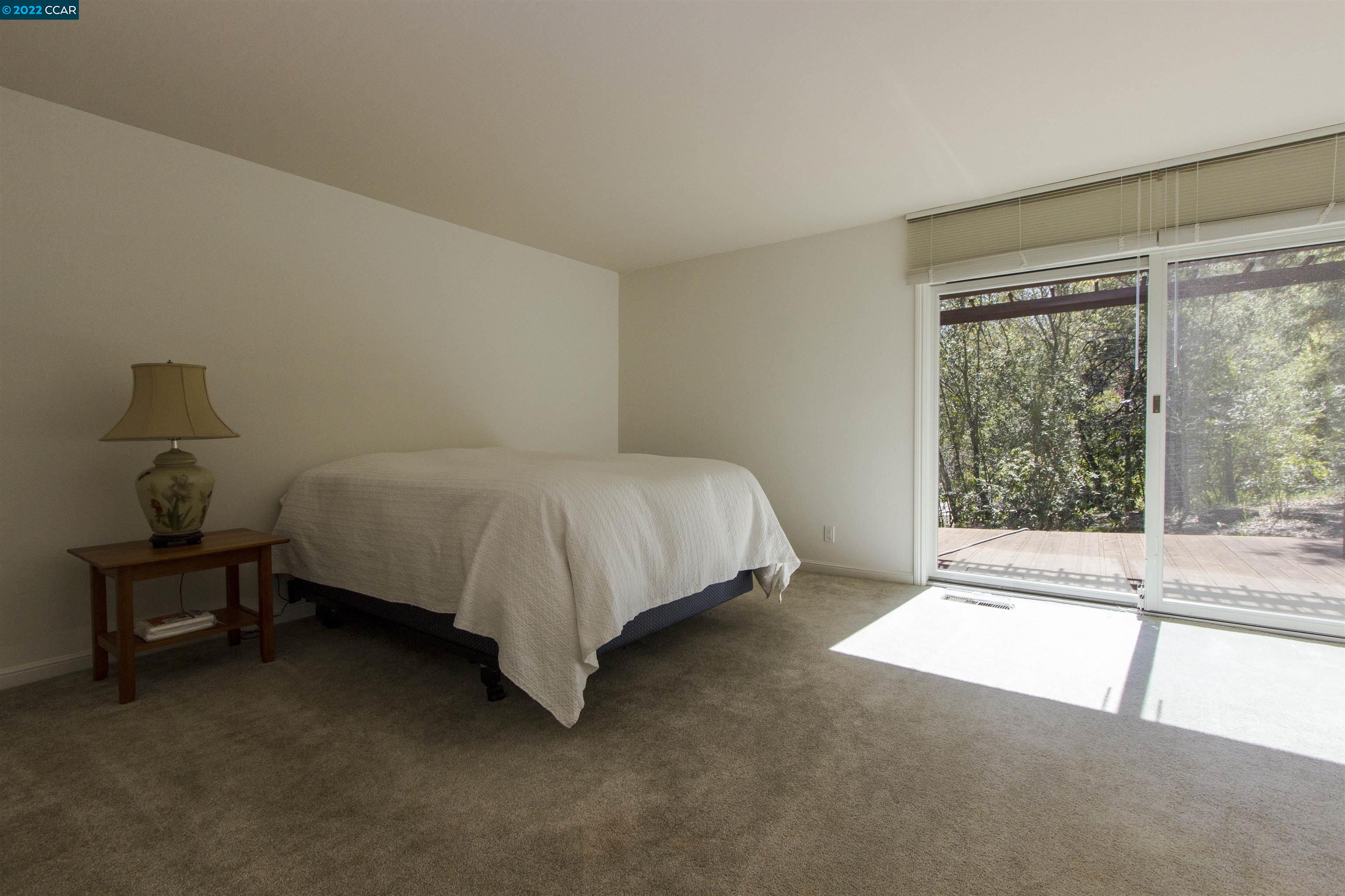 3399 Springhill Road Lafayette, CA 94549 - Photo 16 of 25 a bed sitting in a bedroom next to a window