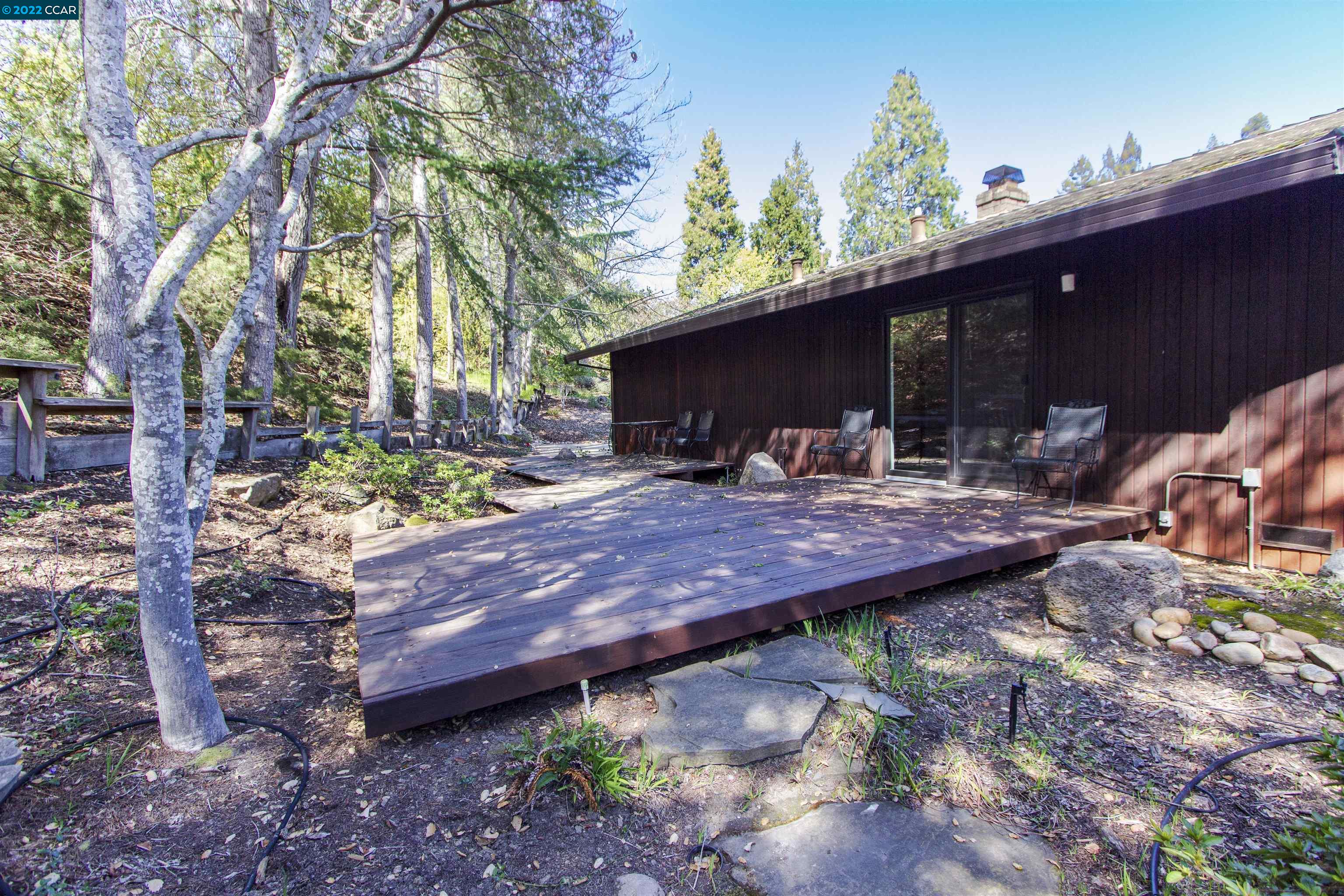 3399 Springhill Road Lafayette, CA 94549 - Photo 22 of 25 a wooden bench sitting in front of a house