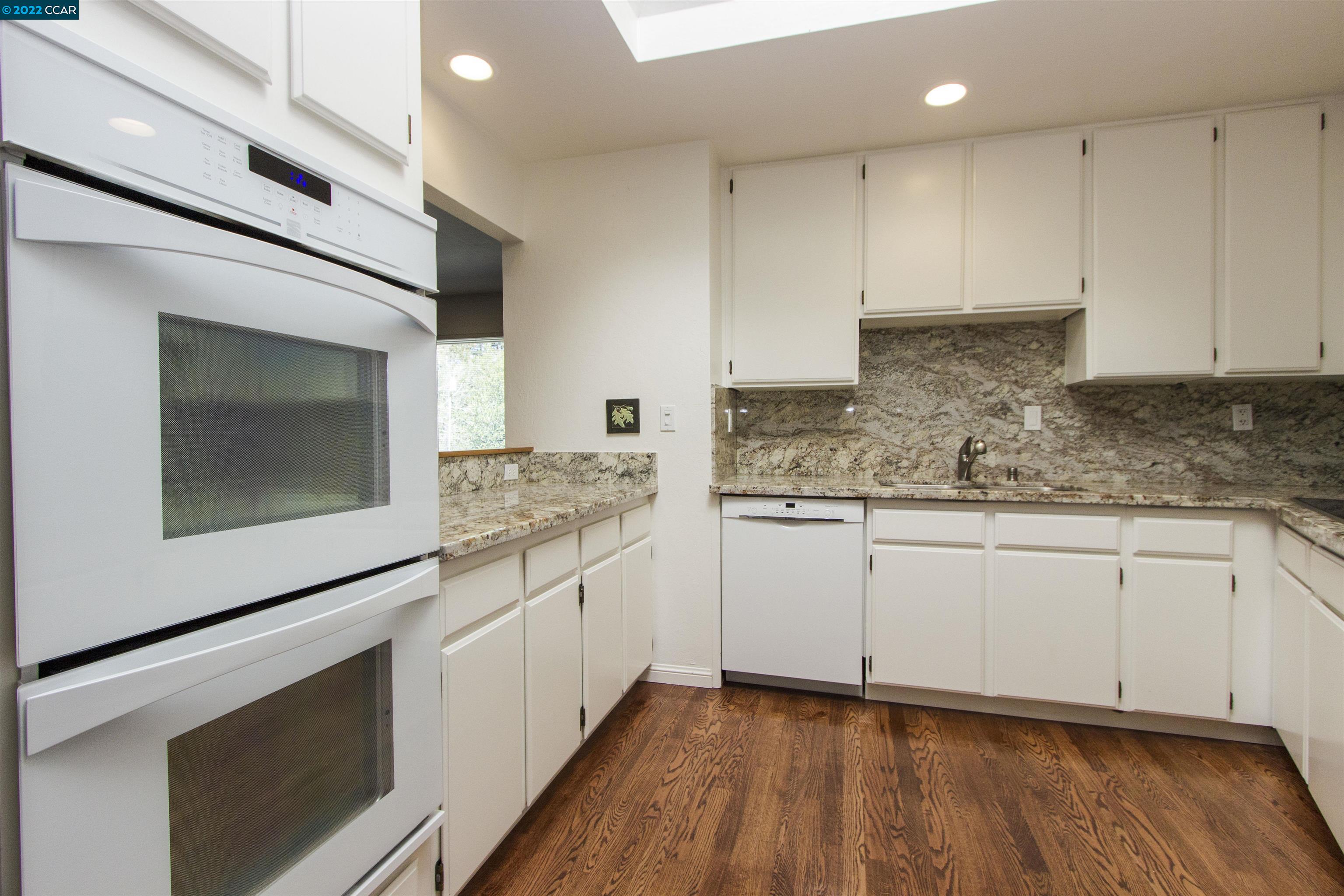 3399 Springhill Road Lafayette, CA 94549 - Photo 4 of 25 a kitchen with granite countertop white cabinets stainless steel appliances and sink