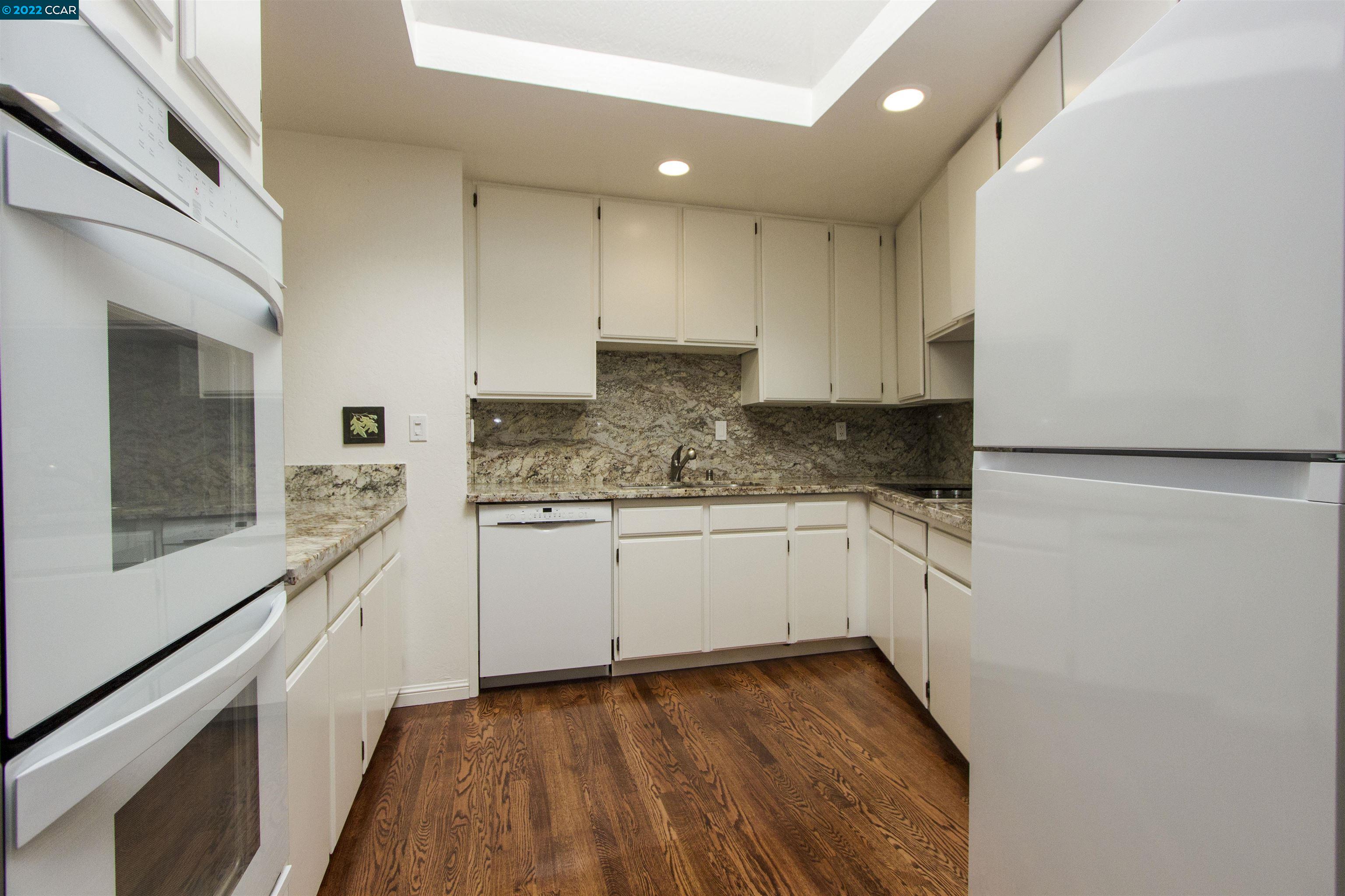 3399 Springhill Road Lafayette, CA 94549 - Photo 5 of 25 a kitchen with granite countertop white cabinets and white appliances