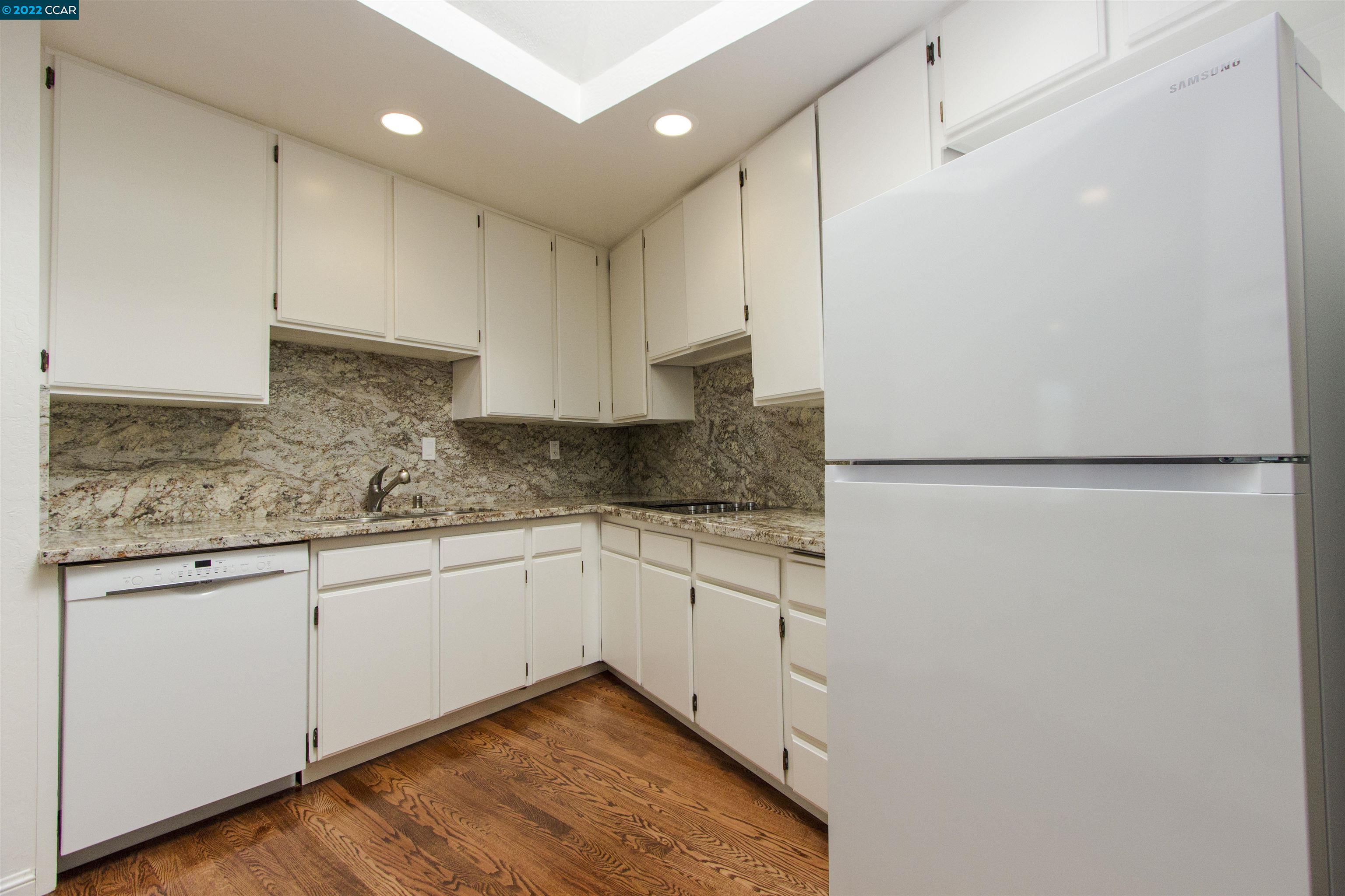 3399 Springhill Road Lafayette, CA 94549 - Photo 6 of 25 a kitchen with granite countertop white cabinets and white appliances
