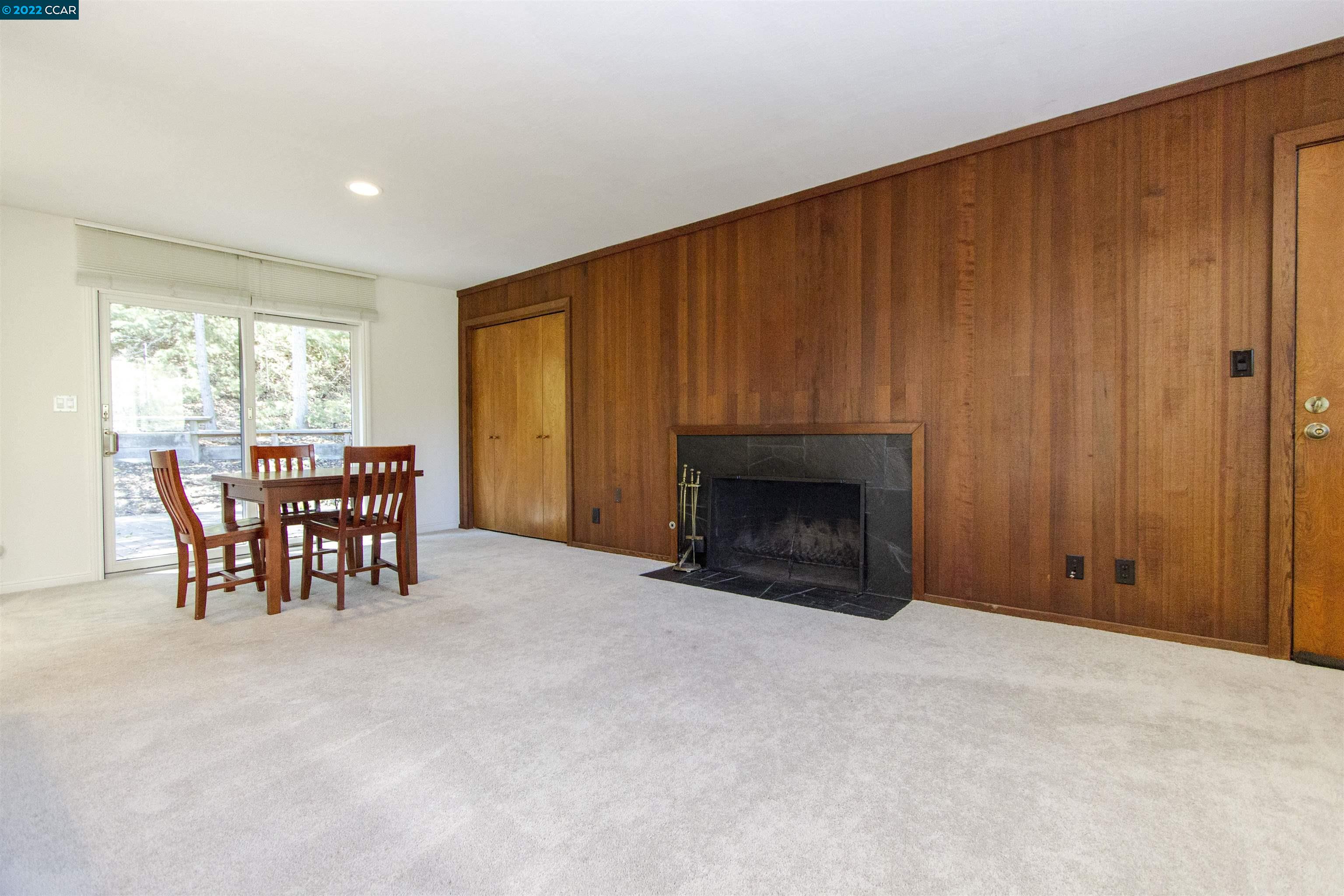 3399 Springhill Road Lafayette, CA 94549 - Photo 8 of 25 a view of an empty room with furniture and a fireplace