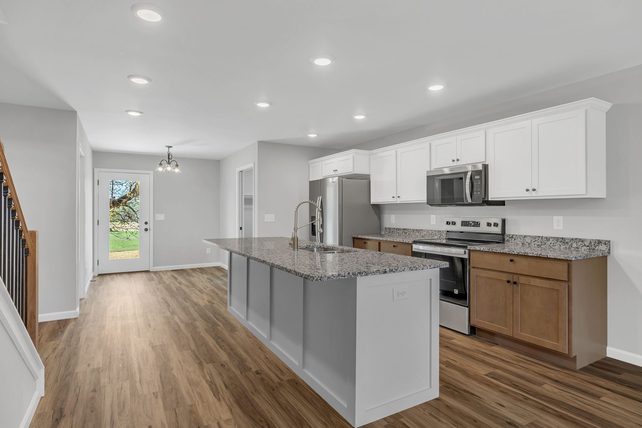 25 Glasner Lane Winchester, TN 37398 - Photo 8 of 32 a kitchen with stainless steel appliances granite countertop a stove top oven a sink dishwasher and a refrigerator with wooden floor