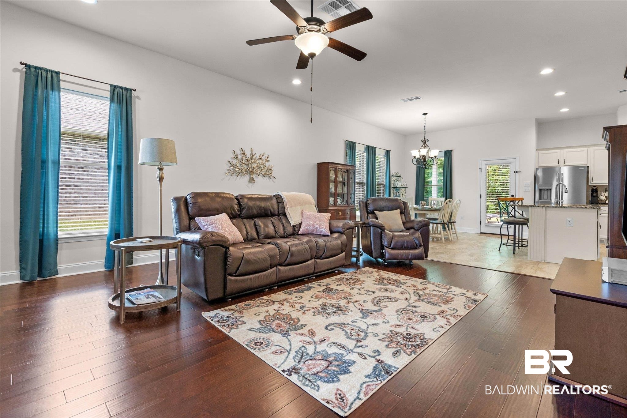 1270 Surrey Loop Foley, AL 36535 - Photo 3 of 27 Spacious living area featuring rich wood-finish flooring and ample natural light from multiple windows