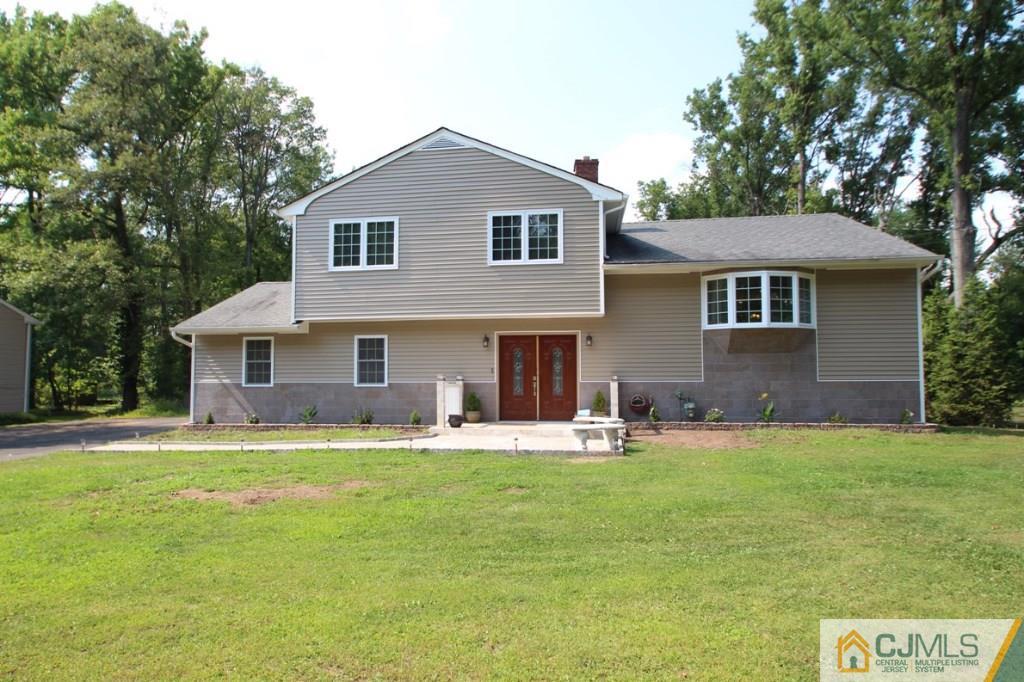 14 Nottingham Road Edison, NJ 08820 - Photo 1 of 19 a front view of a house with a yard and trees