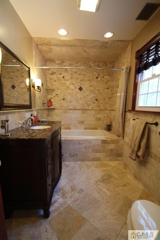 14 Nottingham Road Edison, NJ 08820 - Photo 5 of 19 a bathroom with a double vanity sink a mirror and shower