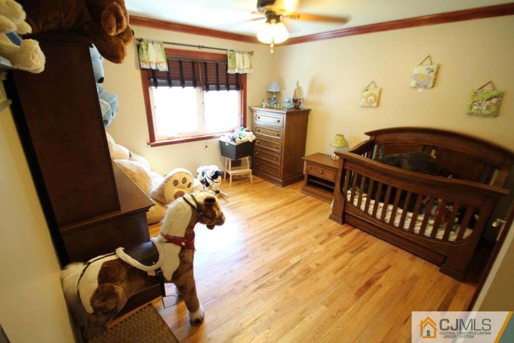 14 Nottingham Road Edison, NJ 08820 - Photo 7 of 19 a bedroom with a bed and wooden floor