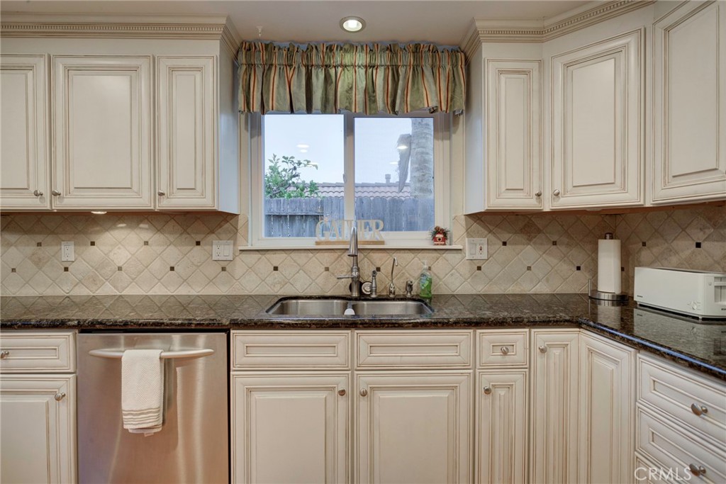 330 Stagecoach Road Arroyo Grande, CA 93420 - Photo 15 of 60 Bright kitchen featuring modern appliances, abundant cabinetry, and a view of the side yard through a large window.