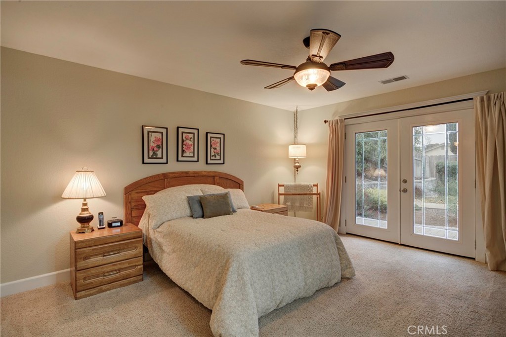 330 Stagecoach Road Arroyo Grande, CA 93420 - Photo 21 of 60 Bright bedroom with a ceiling fan, private access to an outdoor space, and inviting decor.