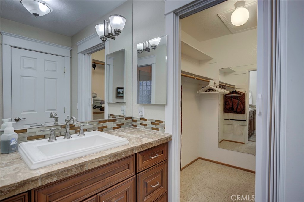 330 Stagecoach Road Arroyo Grande, CA 93420 - Photo 27 of 60 Bright bathroom featuring a double sink, modern fixtures, and a spacious walk-in closet for ample storage.