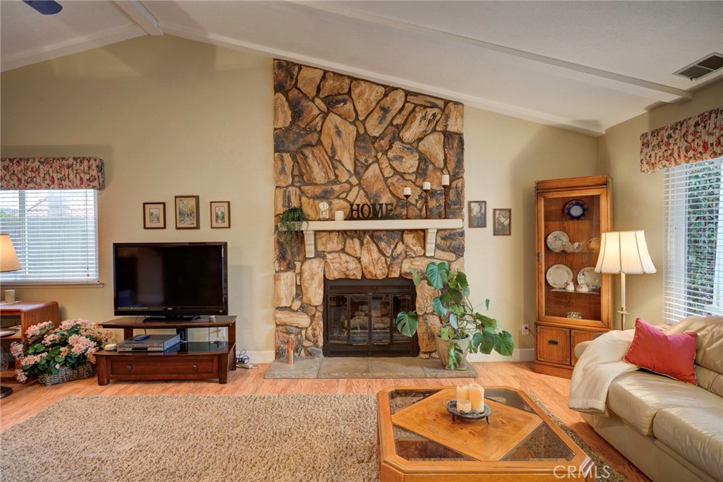 330 Stagecoach Road Arroyo Grande, CA 93420 - Photo 5 of 60 Spacious living room featuring a stone fireplace and ample natural light, perfect for relaxation and gatherings.