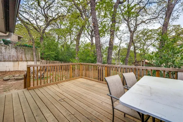 a balcony with wooden floor and outdoor seating