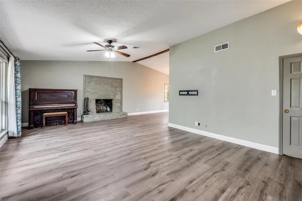 wooden floor in an empty room with a fireplace