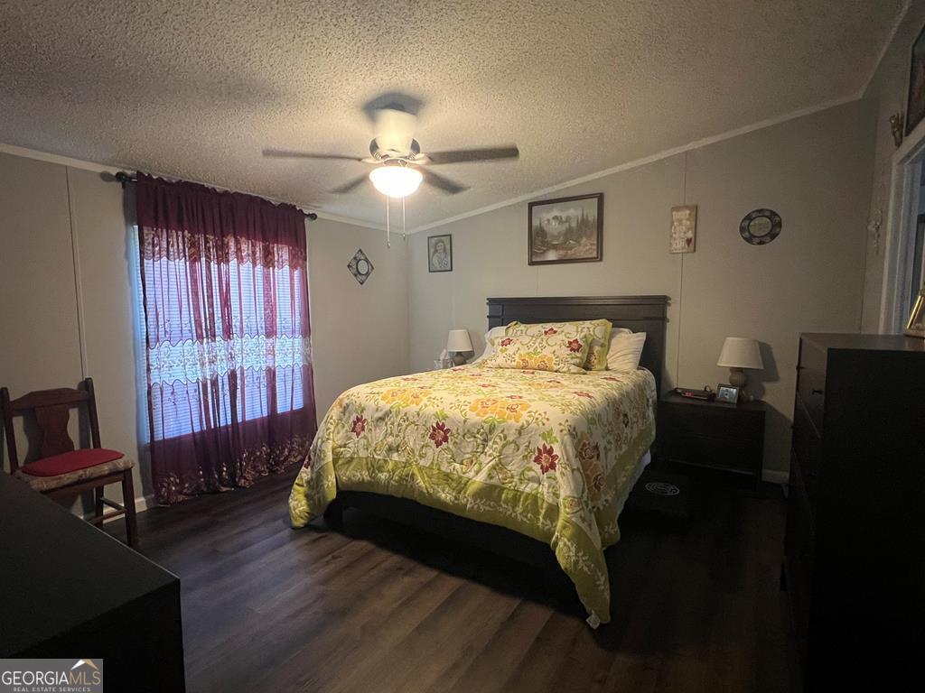 166 Pebble Hills Road Cochran, GA 31014 - Photo 13 of 21 a bedroom with a bed and wooden floor