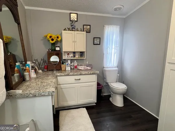 a bathroom with a sink a toilet and mirror