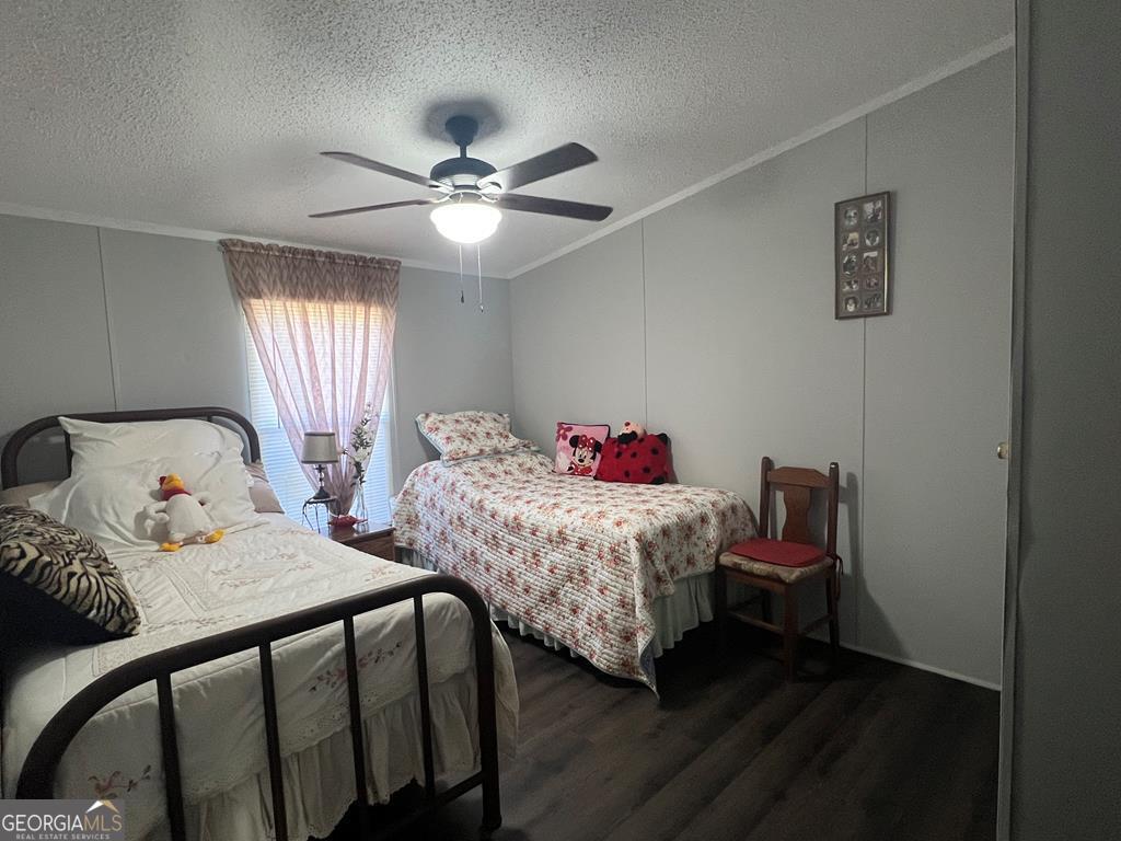 166 Pebble Hills Road Cochran, GA 31014 - Photo 19 of 21 a bedroom with two beds and a chandelier