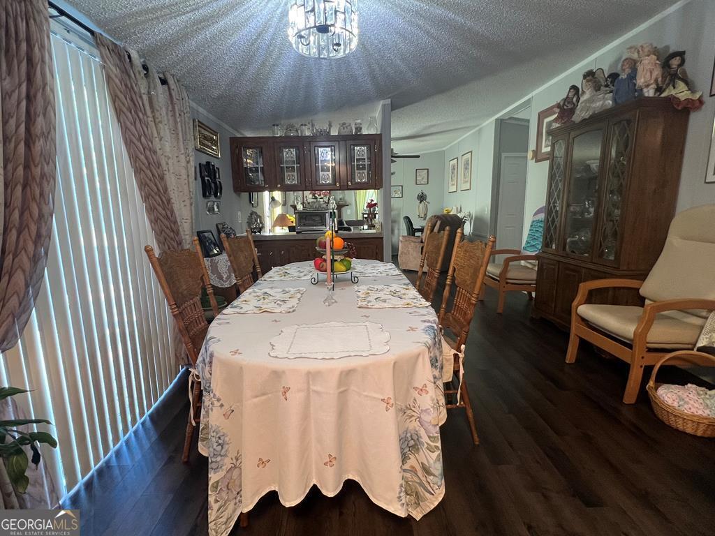 166 Pebble Hills Road Cochran, GA 31014 - Photo 10 of 21 a view of a dining room with furniture window and wooden floor