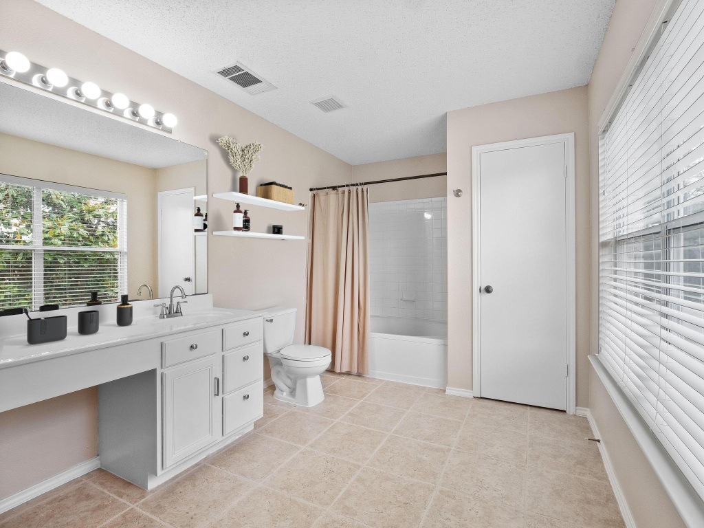 2727 High Point Drive Round Rock, TX 78664 - Photo 13 of 31 Full bathroom with vanity, shower / bath combination with curtain, toilet, tile patterned flooring, and baseboards