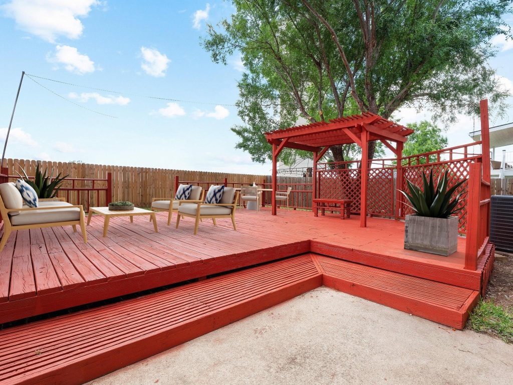 2727 High Point Drive Round Rock, TX 78664 - Photo 18 of 31 Wooden deck with a pergola, a fenced backyard, and outdoor lounge area