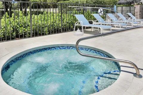 a view of a swimming pool with outdoor seating