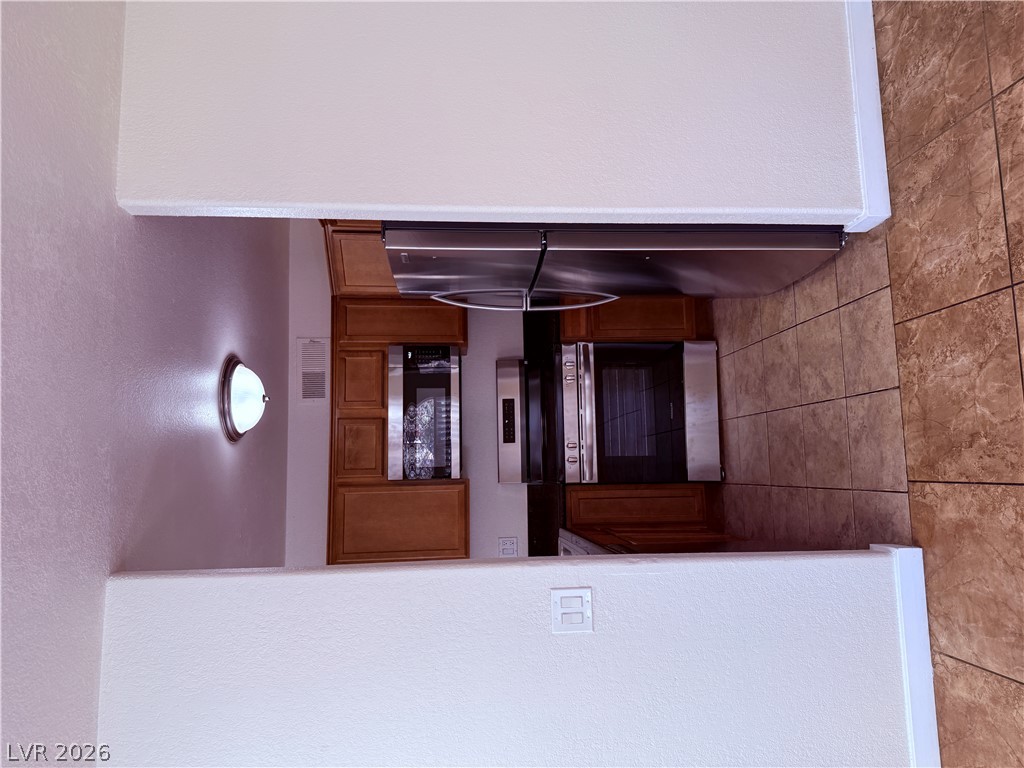 9325 West Desert Inn Road, Unit 260 Las Vegas, NV 89117 - Photo 4 of 42 Stainless steel appliances and tile flooring elevate this functional kitchen space.