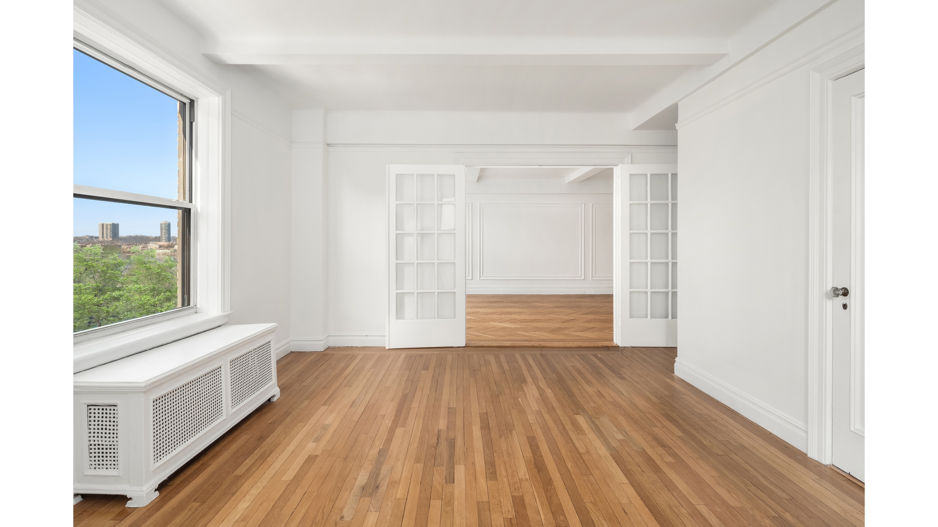 340 Riverside Drive, Unit 6D Manhattan, NY 10025 - Photo 20 of 26 a view of an empty room with wooden floor and a window