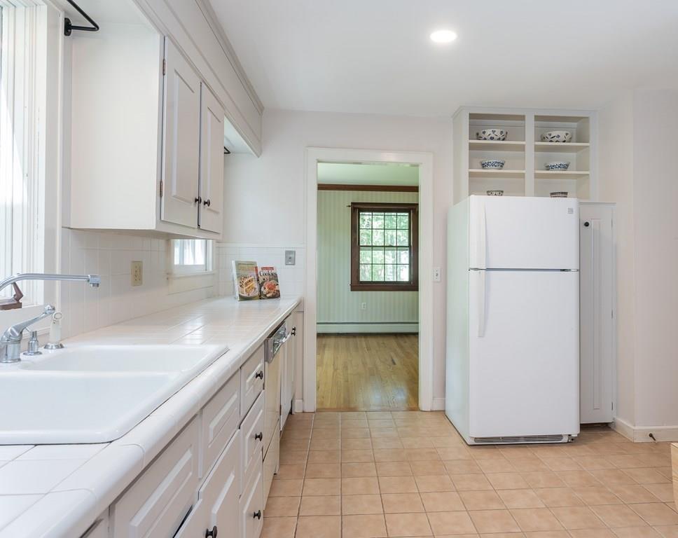 126 Brickyard Road Southampton, MA 01073 - Photo 16 of 41 a kitchen with a sink a refrigerator and cabinets